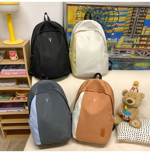 Group display of high-capacity nylon backpacks in black and patchwork color combinations