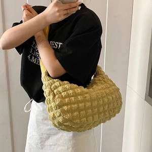Minimalist yellow puff cloud tote bag with stylish bubble texture on a female model