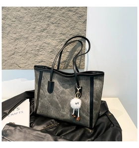 Deep grey marble textured tote bag with black leather edges and cute plush eye charm