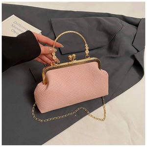 Detail of light pink woven shell bag featuring vintage gold clasp and floral handle