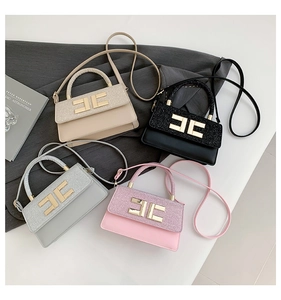 Detail of four chic square handbags in beige, black, gray, and pink with glitter panel