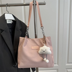 Pink corduroy tote bag with metal chain strap and white plush cloud charm accessory