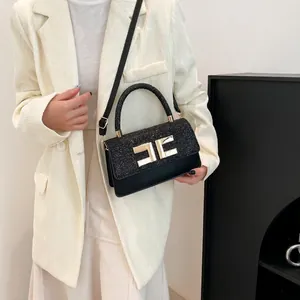 Elegant black glitter crossbody handbag with golden metal logo and adjustable strap