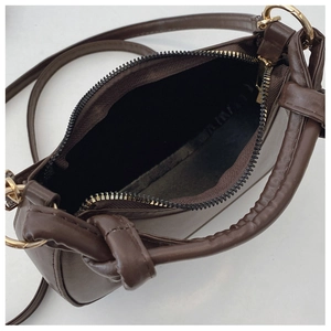 Top view of coffee brown crossbody bag showing zip closure and interior storage