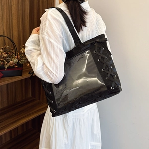 Minimalist black tote bag with transparent window and decorative ribbon accents