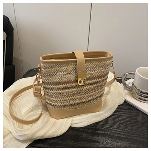 Dettaglio borsa a secchiello in paglia intrecciata con finiture in pelle PU e chiusura oro