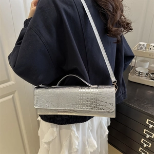 Silver metallic rectangular shoulder bag with crocodile pattern and top handle design