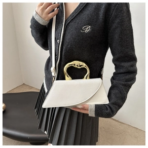 White geometric crossbody bag with a golden semicircular handle and smooth leather texture