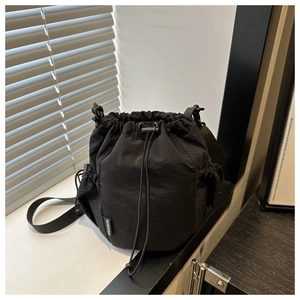 Detailansicht des schwarzen Nylon-Tunnelzugbeutels mit Netztasche und Fashion-Label