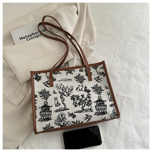 Detail view of landscape rabbit printed tote bag with brown leather trim and handle