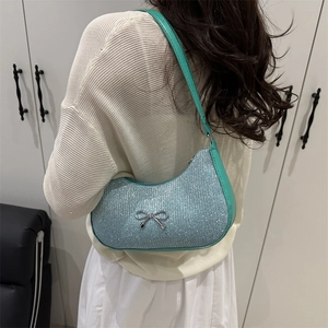 Light blue sequined crescent underarm bag with silver bow accent and green leather trim