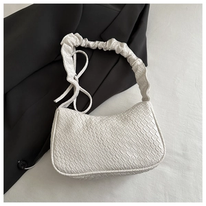 Detail of white woven PU leather handbag with cloud-like ruched handle and half-moon shape