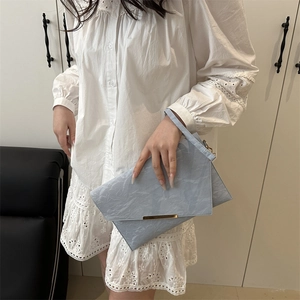 Light blue envelope clutch bag with gold metal buckle and marble texture detail