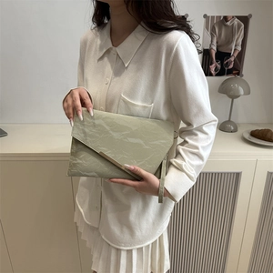 Chic light green envelope clutch bag with wrinkled texture and gold metal trim