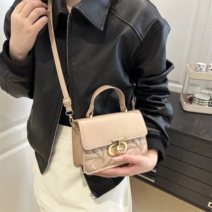 Elegant beige leather crossbody handbag with woven texture and gold twist lock clasp