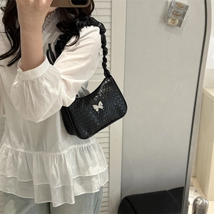Minimalist black woven hobo bag with silver butterfly buckle and ruched shoulder strap