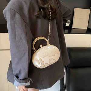 Elegant champagne gold oval evening clutch with floral 3D texture and chain strap