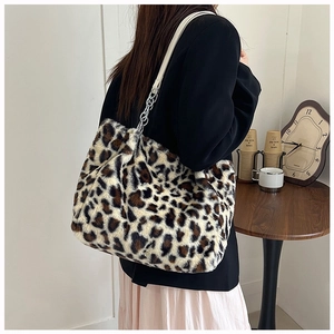 Detail of leopard print plush tote bag with silver chain and white leather strap