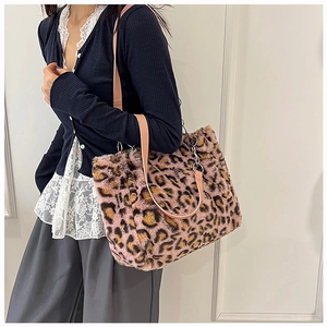 Detail of pink leopard print plush tote bag with soft faux fur texture and metal ring