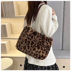 Detail of plush leopard print tote bag with silver chain and leather shoulder strap