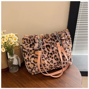Detail of pink leopard faux fur tote with leather straps and silver chain link