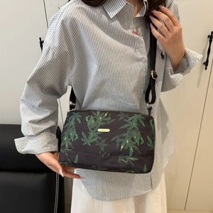 Lightweight black canvas tote bag with green leaf print and adjustable shoulder strap