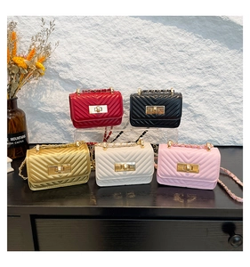 Detail of multi-color V-quilted mini flap bags with gold chain straps and metal locks