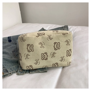 Close-up of cream corduroy tote bag with cute bear print and soft ribbed texture detail