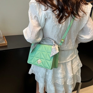 Mint green quilted handbag with floral scarf handle and silver twist lock on model