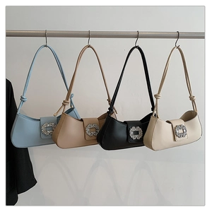 Detail of four chic faux leather shoulder bags in blue, camel, black, and beige colors