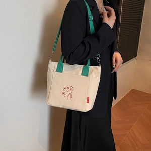 Cream canvas bucket tote bag with green straps and cute bear embroidery for women