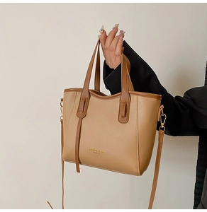 Detail of khaki contrast tote bag showing fashion leather text and smooth matte texture