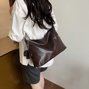 Minimalist coffee brown PU leather tote bag with silver chain mini purse on model