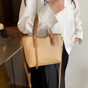 Chic two-tone contrast tote bag with top handle and adjustable crossbody strap