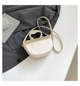 Close-up of saddle bag featuring liquid metal handle and woven texture details