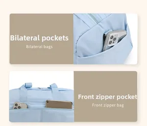 Detail of light blue travel bag featuring side pockets and a front zipper storage pouch