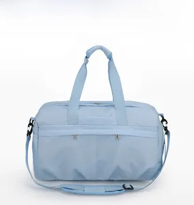 Detail view of large light blue waterproof travel bag with dual handles and side pocket