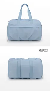 Detail view of the light blue travel bag with luggage sleeve and reinforced straps