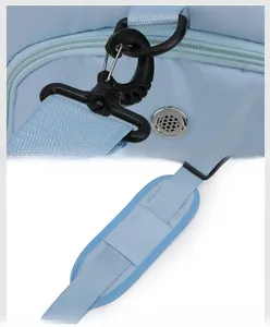 Detail of light blue bag featuring a detachable swivel hook and a padded shoulder strap