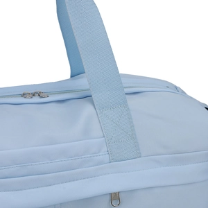 Close-up of sturdy cross-stitch handle reinforcement on light blue nylon travel bag
