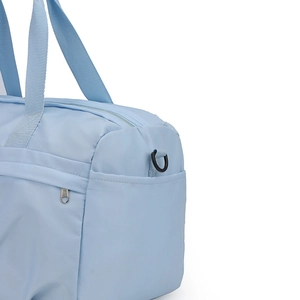Close-up of light blue travel bag showing durable nylon fabric and reinforced strap handle