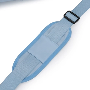 Detail of adjustable blue nylon shoulder strap with cushioned pad and buckle for travel bags