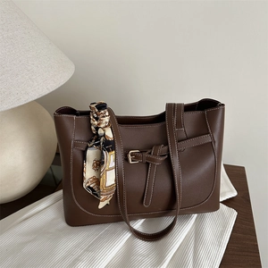 Deep brown minimalist tote bag with contrast stitching and decorative silk scarf
