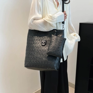 Black tote bag with skull embossing and silver metal skull detail for gothic style