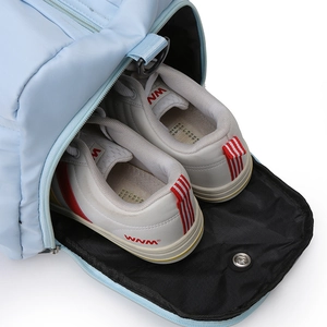 Close-up of sky blue gym bag featuring a dedicated side zippered shoe compartment