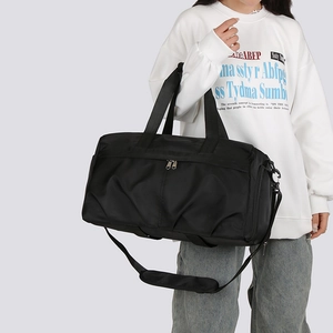 Detail of durable black nylon travel bag with adjustable padded strap and zippers