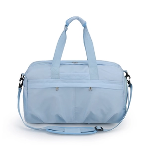 Close-up of light blue travel bag featuring dual handles and adjustable shoulder strap