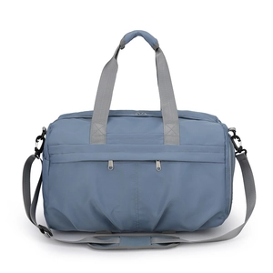 Close-up of durable blue-grey nylon travel bag with reinforced grey handles and metal zippers