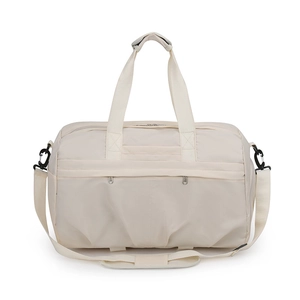 Close-up of beige waterproof travel bag featuring reinforced handles and adjustable strap
