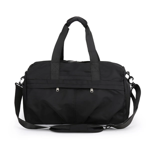 Close-up of black waterproof nylon travel bag featuring dual zippers and reinforced handles